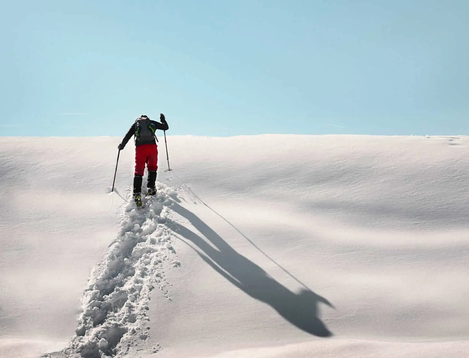 trekking poles being used in the snow